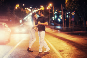 young couple dancing on the road.