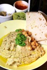 Hummus served with parsley and chickpeas