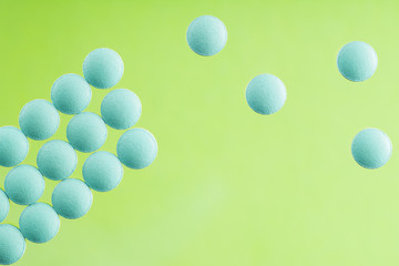 pile of medical pills on light glass background