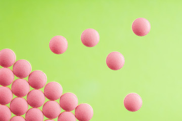 pile of medical pills on light glass background