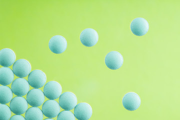 pile of medical pills on light glass background