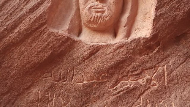 Rock carving of the head of Lawrence of Arabia in Wadi Rum desert in Jordan. Wadi Rum, also known as Valley of Moon, is the largest wadi in Jordan, that consists of sand, sandstone and granite rocks
