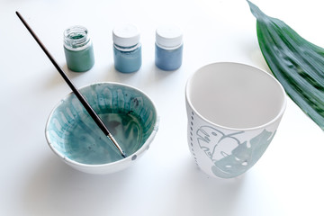 painted ceramic cup on white background