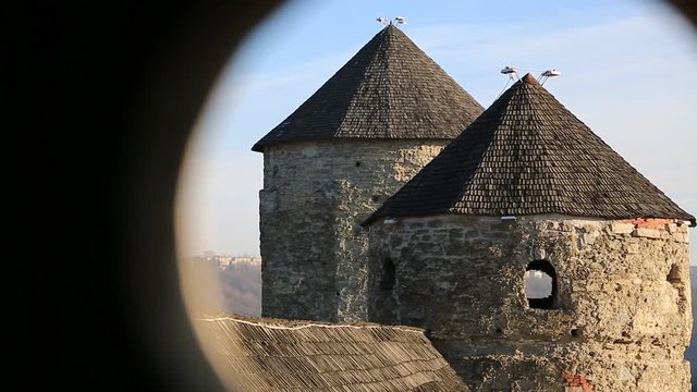 Old Ruthenian-Lithuanian castle and later Polish fortress, located in historic city of Kamianets-Podilskyi, historic region of Podolia, Ukraine. View on two towers from round window inside other tower