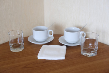 caps, napkins and glasses on a table