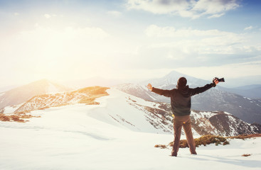 tourist looks at the landscape. Photographer on top of mountain
