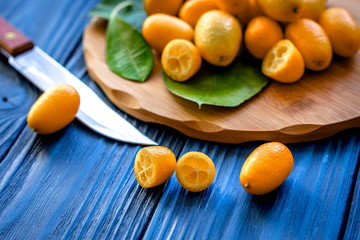 kumquat on plate at wooden table