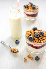 Fitness breakfast with muesli and milk on white table