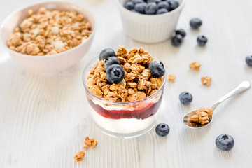 Healthy morning with granola breakfast on white kitchen table