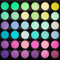 Colorful beauty makeup powder background. Top view