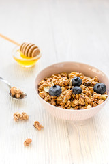 Healthy morning with granola breakfast on white kitchen table