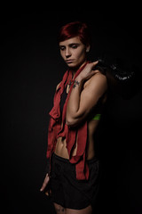 Fototapeta na wymiar Tired boxer woman after the training in dark room