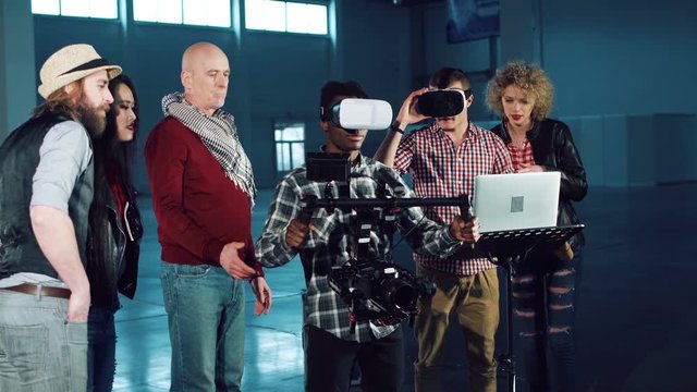 People shooting on special camera wearing vr headset.