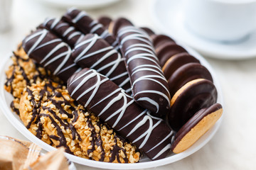 hand holding Chocolate Chip Cookies on dish isolated on white background
