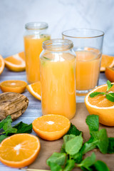 Obraz na płótnie Canvas healthy morning with orange juice in bottle on kitchen background