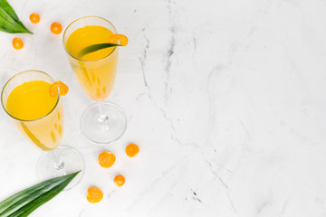 cocktail with physalis in glass on stone background