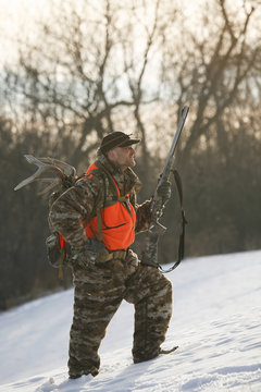 Hunter Walking Through Snow While Hunting For Whitetail Deer