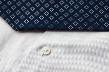 close up of shirt and blue patterned tie