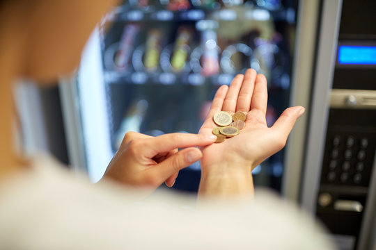 Woman Counting Euro Coins At Vending Machine