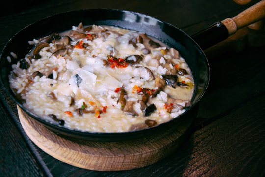 Risotto with mushrooms in cooking pan. Healthy vegetarian meal.