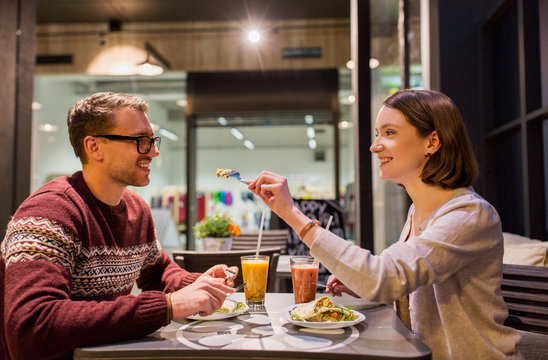 happy couple eating dinner at vegan restaurant