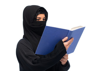 muslim woman in hijab reading book over white