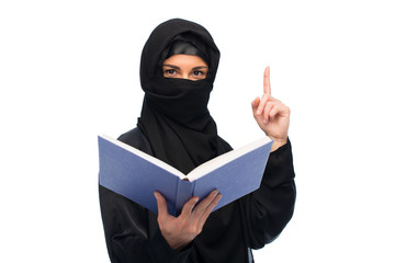 muslim woman in hijab with book over white