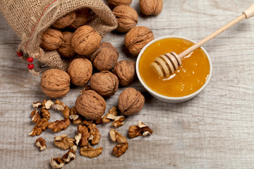 Whole walnuts, kernels and honey on the table