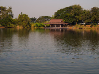 Fototapeta premium Wide river with green forest and sky with clouds.