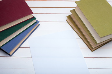 hardcover books and the sheet of paper.