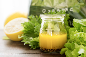 bottle of homemade basic salad dressing made with olive oil lemon juice honey salt and black pepper