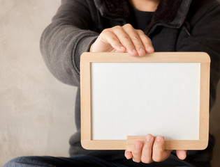 Woman holding a blank whiteboard