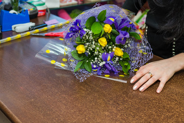 The florist who is wrapping up flowers