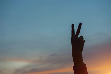 Shadow of two fingers at sunset