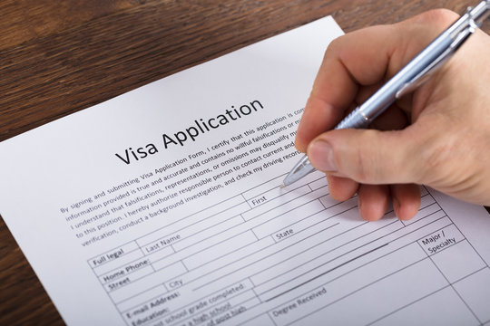 Person Filling Visa Application Form