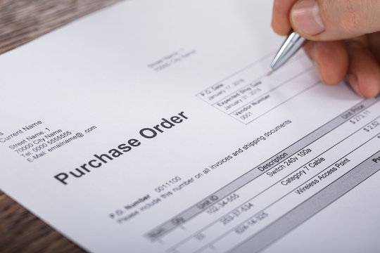 Person Filling A Purchase Order Form