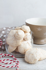 meringue in a glass jar, tea cup on a white background