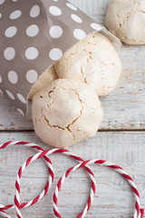 Meringue in a paper bag on a white background closeup