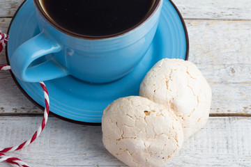 Black coffee and meringue closeup