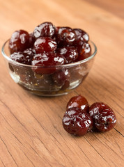 closeup monkey apple fruit in syrup on wood background
