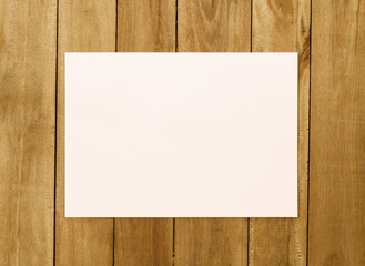 White paper on wood background © PThira89