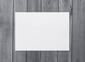 White paper on wood background