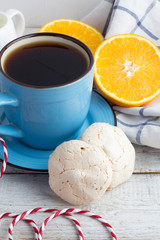 meringue in a glass jar, coffee and oranges