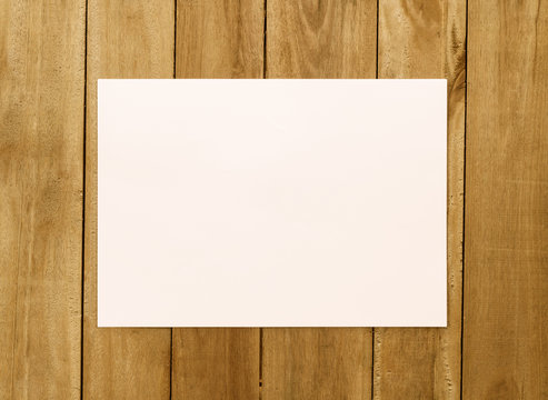 White paper on wood background
