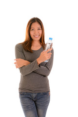 Smling casual woman crossing arms and holding a bottle of  water on white background.