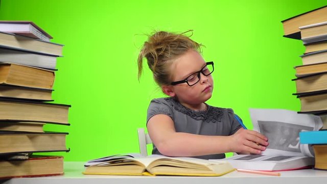 Girl leafing through the pages of books carefully. Green screen. Slow motion
