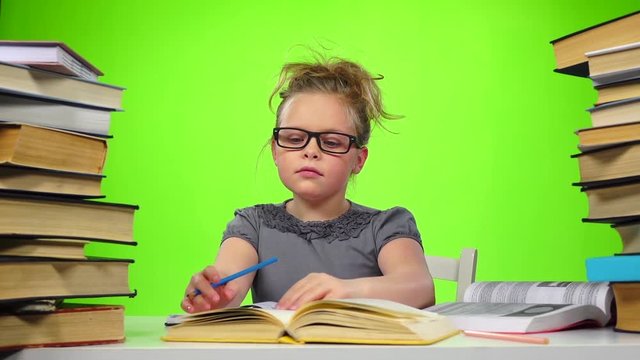 Girl leafing through the pages of books carefully. Green screen. Slow motion