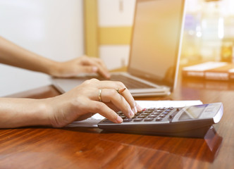 woman working with calculator, business document and laptop computer notebook,business  finance, selective focus