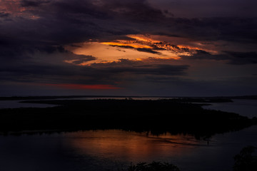 Fototapeta na wymiar Yellow And Red Sky Over Lake Island. At Lakes Entrance