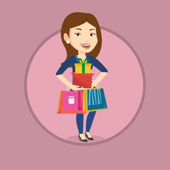 Happy woman holding shopping bags and gift boxes.